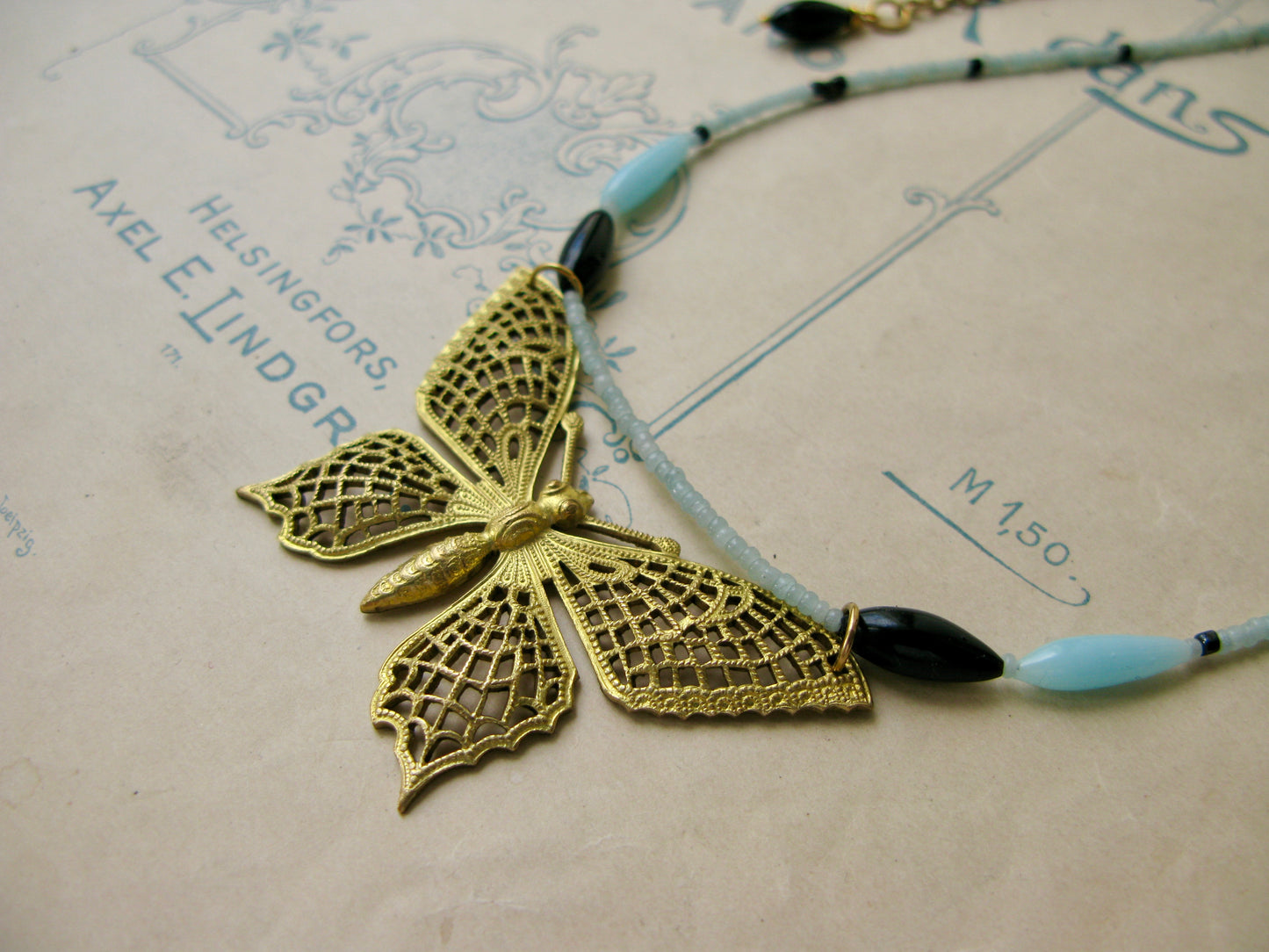 Papillon necklace in aqua + black