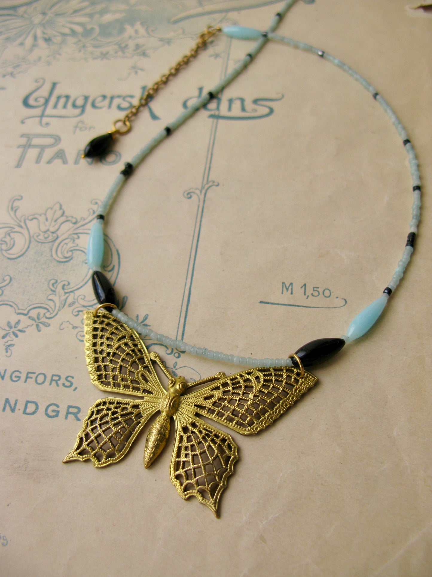 Papillon necklace in aqua + black