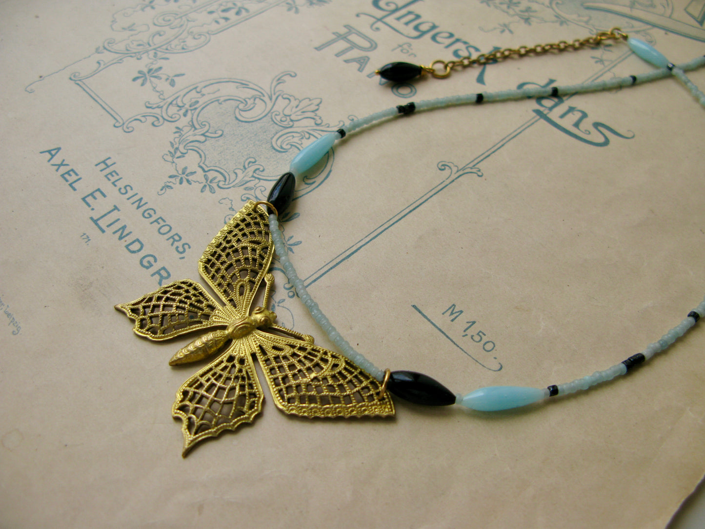 Papillon necklace in aqua + black