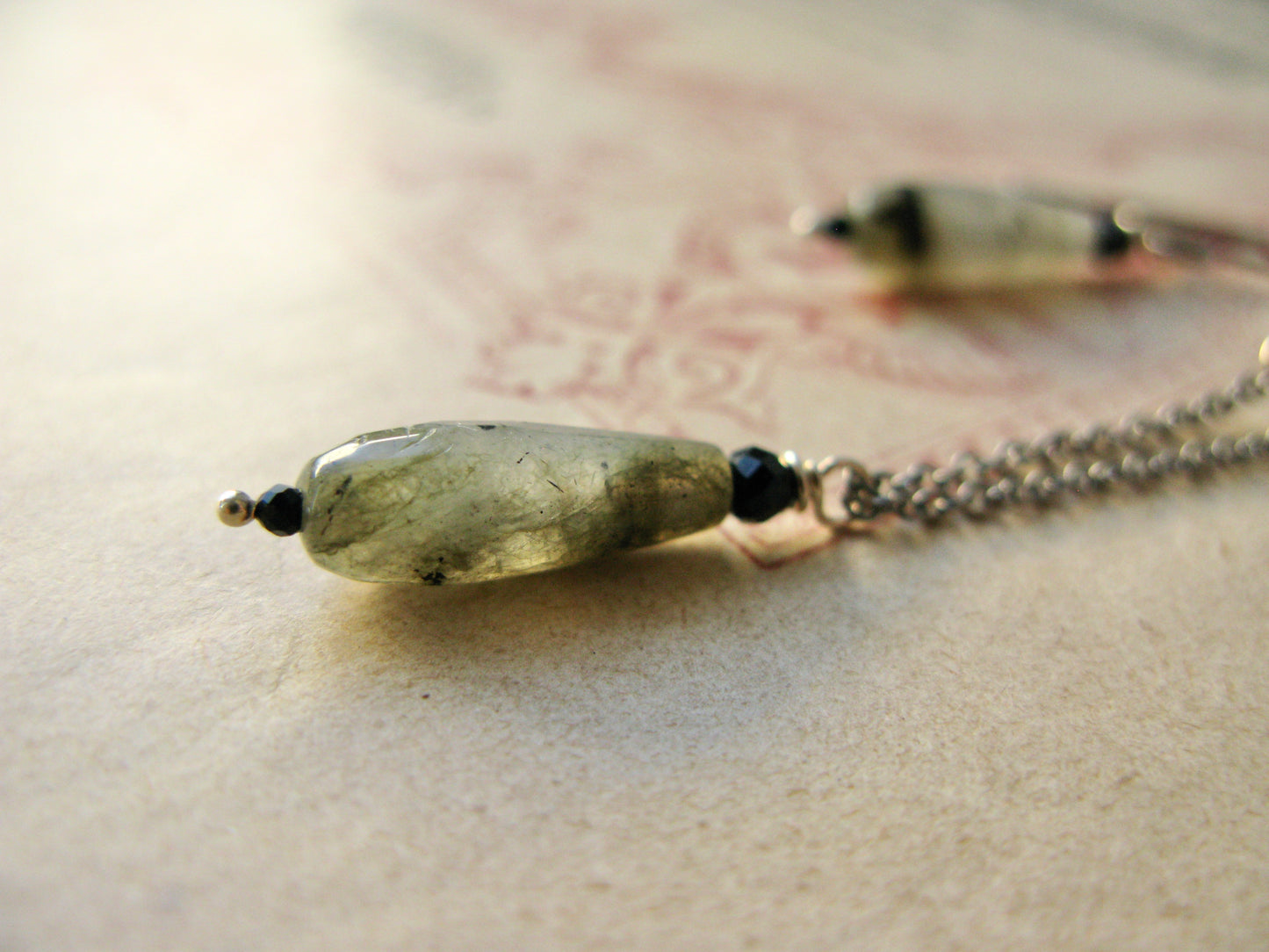 Detail view of earrings with labradorite stones
